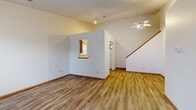 Located at 930 King Rd in Newark, Ohio, this two-story home offers a practical and comfortable layout across two floors. The main level provides a generous living area featuring warm hardwood-style flooring, a ceiling fan, and a staircase that leads to the upper level. A distinctive pass-through window connects the living space to an adjacent area, adding an open, airy feel to the main floor. The entryway welcomes natural light through a large front-facing window, complemented by a classic six-panel door and clean, neutral wall tones throughout.

The upper floor houses the bedrooms, including a spacious primary bedroom, with carpeted flooring providing warmth and comfort. Upper-level rooms feature vaulted ceilings that lend a sense of height and character, with windows drawing in natural light. Built-in storage accents can be found in select rooms upstairs.

Both bathrooms are equipped with a full tub-shower combination featuring decorative surround panels, hardwood-style flooring, and vanity cabinetry, offering a clean and functional design. Two closets provide added storage convenience throughout the home. With two living rooms, four bedrooms, and a well-connected layout, this home delivers versatile space suitable for a variety of living arrangements.