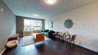 Located at 22 Sussex in Hackensack, NJ, this well-appointed single-floor residence combines modern design with functional living. Dark hardwood flooring runs throughout, providing a warm, cohesive foundation for the entire space.

The open living and dining area is a standout feature, bathed in natural light from large windows that frame views of the surrounding cityscape. The living space comfortably accommodates a full seating arrangement alongside a compact dining set, with clean white walls accented by a distinctive gold-framed geometric mirror that adds a touch of character.

The kitchen is efficiently designed with two-tone cabinetry featuring warm wood lower cabinets and light upper cabinets, complemented by a crisp quartz countertop and a stainless steel gas range with over-range microwave.

The bedroom offers a serene retreat with generous natural light from a wide window overlooking greenery and city views. Ample closet storage is provided by a set of double closets. Dark hardwood floors continue here, maintaining design continuity throughout.

The bathroom is thoughtfully finished with pebble mosaic floor tile, large-format wall tile in the tub/shower surround with wood-look accent tiling, and a floating vanity beneath a backlit mirror, creating a clean and contemporary aesthetic throughout.