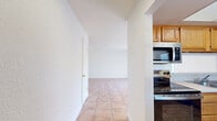 This 870 square foot apartment, located in Summit West - 43C - B1, offers a thoughtfully designed living space with two bedrooms and one bathroom. The single-story layout maximizes functionality within its compact footprint. The primary bedroom, measuring 160 square feet, provides a comfortable retreat.

The living area features a combination of carpeted and tiled flooring, creating distinct zones for relaxation and dining. Large windows in the bedrooms and living spaces allow ample natural light, enhancing the sense of openness. The modern kitchen is equipped with stainless steel appliances, including a refrigerator and dishwasher, complemented by wooden cabinetry and a convenient over-the-range microwave.

The bathroom, while not expansive, offers essential amenities with a standard tub-shower combination. Storage solutions include a walk-in closet, providing additional organizational space. The neutral color palette throughout the apartment creates a versatile canvas for personal decor styles.

This apartment strikes a balance between comfort and efficiency, making it an ideal choice for small families, couples, or individuals seeking a cozy yet functional living environment. Its layout optimizes the available space, ensuring each square foot is utilized effectively.