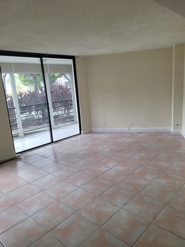 Dining and living room with balcony - 20400 W Country Club Dr