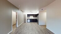 Located at 3141 Willow Creek Rd in Prescott, Arizona, this single-floor unit offers two bedrooms and two bathrooms in a well-designed, contemporary layout. The open-concept living and kitchen area features light-toned luxury vinyl plank flooring that extends throughout the main living spaces, creating a clean and cohesive aesthetic. The kitchen is appointed with rich, dark espresso cabinetry, granite-style countertops, and a full suite of stainless steel appliances including a refrigerator, range, microwave, and dishwasher — providing both style and functionality. Both bedrooms are carpeted for comfort and receive natural light through windows fitted with horizontal blinds, offering views of the surrounding community. The two bathrooms echo the kitchen's design language, featuring matching dark cabinetry with granite-style vanity tops. One bathroom includes a full soaking tub and shower combination with built-in shelving, while the second bathroom offers a separate shower and a large mirror above the vanity. Neutral wall tones throughout the unit create a versatile backdrop, and the open layout between the living area and kitchen promotes a spacious, airy feel ideal for everyday living.