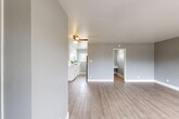 Located at 1737 Cormorant Way in Sacramento, California, this efficiently designed single-floor unit offers a thoughtful layout comprising a living room, kitchen, bathroom, and closet. The interior is finished with light wood-look flooring that runs throughout, complemented by soft gray walls and crisp white trim, creating a clean and modern aesthetic.

The open living area is bright and inviting, benefiting from large windows that usher in generous natural light and offer views of the surrounding neighborhood. A ceiling fan adds both function and character to the space.

The kitchen is well-equipped with white shaker-style cabinetry, sleek quartz countertops featuring brushed nickel hardware, and stainless steel appliances. A window above the counter provides additional natural light and a pleasant outdoor view, making the kitchen feel open despite its compact footprint.

The bathroom is tastefully updated, showcasing a walk-in shower with a pebble stone floor, stone-surround walls, and a curved shower rod. A white vanity with a quartz countertop and a mirror complete the space, while soft gray walls tie the design together cohesively.

The closet provides practical storage, and the overall neutral color palette throughout the unit ensures a versatile and move-in-ready environment. This space is ideal for those seeking a modern, low-maintenance layout in Sacramento.