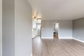 Located at 1737 Cormorant Way in Sacramento, California, this efficiently designed single-floor unit offers a thoughtful layout comprising a living room, kitchen, bathroom, and closet. The interior is finished with light wood-look flooring that runs throughout, complemented by soft gray walls and crisp white trim, creating a clean and modern aesthetic.

The open living area is bright and inviting, benefiting from large windows that usher in generous natural light and offer views of the surrounding neighborhood. A ceiling fan adds both function and character to the space.

The kitchen is well-equipped with white shaker-style cabinetry, sleek quartz countertops featuring brushed nickel hardware, and stainless steel appliances. A window above the counter provides additional natural light and a pleasant outdoor view, making the kitchen feel open despite its compact footprint.

The bathroom is tastefully updated, showcasing a walk-in shower with a pebble stone floor, stone-surround walls, and a curved shower rod. A white vanity with a quartz countertop and a mirror complete the space, while soft gray walls tie the design together cohesively.

The closet provides practical storage, and the overall neutral color palette throughout the unit ensures a versatile and move-in-ready environment. This space is ideal for those seeking a modern, low-maintenance layout in Sacramento.