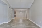 Located at 315 Vandiver Rd in Canton, GA, this single-floor home offers a thoughtfully designed layout with modern finishes throughout. The open-concept living area is anchored by light wood-look flooring, a ceiling fan, and a stylish chandelier that illuminates the transition into the kitchen. Neutral gray walls carry consistently through every room, creating a cohesive and contemporary aesthetic.

The kitchen is well-equipped, featuring dark espresso cabinetry, granite countertops, a tiled backsplash, black appliances including a range, microwave, refrigerator, and dishwasher, plus a dedicated pantry with built-in shelving. A peninsula with a sink adds additional prep and storage space.

A central hallway connects the bedrooms and bathrooms, finished with crown molding and the same wood-look flooring seen in the living areas. The bedrooms are carpeted and each includes a ceiling fan and window with blinds, providing natural light and comfort. Closet space is available, including what appears to be a walk-in option.

The bathroom features a full tub-shower combination with brushed nickel fixtures, a granite-topped vanity with dark cabinetry, and wood-look flooring. A second bathroom includes an additional tub-shower unit. The overall design balances practicality with clean, modern styling throughout.