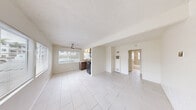Located on Segovia Road in Goleta, California, this thoughtfully designed one-bedroom, one-bathroom home makes excellent use of its compact footprint across a single floor. Light-toned large-format tile flooring runs throughout the space, reflecting natural light and creating a bright, cohesive aesthetic.

The kitchen is a functional standout, featuring warm wood-grain cabinetry, quartz countertops with a double basin sink, a window with natural light, and a full suite of stainless steel appliances including a gas range, microwave, and refrigerator. Ample upper and lower cabinetry, along with a built-in pantry, ensures generous storage.

The bedroom is a serene, sun-filled retreat with a large window framing lush greenery outside. A wall of custom built-in cabinetry provides extensive storage, incorporating floor-to-ceiling wardrobes flanking a central illuminated niche with built-in drawers — a practical and polished solution for organization.

The bathroom is elegantly finished with large-format marble-look porcelain wall tiles, a soaking tub with shower, chrome fixtures, and a frosted window for privacy and natural light. A hallway connects the rooms efficiently, completing this well-organized layout. The textured ceilings and crisp white walls throughout lend the home a clean, move-in-ready character.
