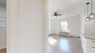 Located on North Clark Street in Chicago's sought-after Lincoln Park neighborhood, this one-bedroom, one-bathroom unit offers a well-considered layout across a single floor. The bedroom is generously proportioned, bathed in natural light through multiple windows, and features classic parquet wood flooring that adds warmth and character throughout. A ceiling fan provides year-round comfort, while a traditional cast-iron radiator reflects the building's historic charm. The crisp white walls and abundant sunlight create an open, airy atmosphere. The kitchen has been thoughtfully updated with white shaker-style cabinetry, granite countertops, a white subway tile backsplash, and marble-look tile flooring. Stainless steel appliances — including a refrigerator, dishwasher, and gas range — along with a built-in microwave, complete the modern culinary setup. The bathroom continues the clean, updated aesthetic with bright white subway tile lining the tub surround for a polished, timeless finish. The overall design balances classic architectural details with contemporary finishes, resulting in a cohesive and functional living space well-suited for everyday life in one of Chicago's most vibrant urban neighborhoods.