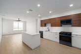 Located at 3585 Aero Ct in San Diego, CA, this thoughtfully designed 3-bedroom, 2-bathroom residence offers a bright and modern living experience across a generous single-floor layout. Light wood-tone flooring flows throughout, complementing the clean white walls and contemporary aesthetic found in every room.

The open-concept living, dining, and kitchen area serves as the heart of the home. The kitchen is outfitted with two-tone cabinetry — warm wood uppers paired with crisp white lowers — set against a white tile backsplash. Stainless steel appliances, including a gas range, over-range microwave, dishwasher, and refrigerator, complete the space, along with a central island that enhances both prep space and flow.

The spacious primary bedroom features a ceiling fan, large windows framing outdoor views of the surrounding San Diego landscape, and generous closet space. The two additional bedrooms are equally well-lit, each with ceiling fans and windows offering pleasant outdoor views. Six closets total provide exceptional storage throughout the unit.

Both bathrooms are finished with large-format neutral tiles, soaking tubs with tub-shower combinations, matte black fixtures, and warm wood vanity cabinetry. A dedicated laundry area and a private balcony round out the functional and comfortable offerings of this well-appointed San Diego residence.