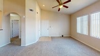 This 910 square foot apartment in Las Vegas offers a blend of comfort and functionality. The unit features two bedrooms, including a primary bedroom of 150 square feet, and two full bathrooms. The open-concept living area combines the kitchen and living room, creating a spacious feel. The modern kitchen boasts wood-tone cabinetry, black appliances, and a convenient breakfast bar. Ceiling fans throughout provide air circulation, while multiple windows allow for abundant natural light. The unit includes an in-unit laundry room with full-size washer and dryer, enhancing convenience. Neutral-toned walls and carpeting in the bedrooms and living areas create a versatile backdrop for various decor styles. Tiled flooring in the kitchen and bathrooms adds durability and easy maintenance. The bathrooms feature modern vanities and tub/shower combinations. Ample closet space in bedrooms and hallways offers plenty of storage options. This single-story unit combines practicality with comfort, ideal for those seeking a turnkey living solution in Las Vegas.