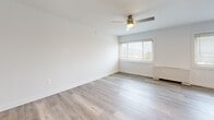 Located at 8415 Bellona Ln in Towson, MD, this thoughtfully designed one-bedroom residence offers a clean, contemporary aesthetic throughout its efficiently organized single-floor layout. The open-concept living, dining, and kitchen area is anchored by light-toned luxury vinyl plank flooring, recessed lighting, and a ceiling fan, creating a bright and airy atmosphere. Large windows fitted with blinds invite natural light into the living area, enhancing the sense of openness.

The kitchen is well-appointed with white shaker-style cabinetry, gray lower cabinets, a subway tile backsplash, light quartz countertops, and a full suite of stainless steel appliances including a gas range, microwave, dishwasher, and refrigerator. A peninsula countertop provides additional workspace and a casual dining option. Notably, an in-unit washer and dryer are integrated seamlessly within the kitchen area.

The spacious bedroom features plush carpeting, a ceiling fan with light, and two closets offering substantial storage. The bathroom is finished with a gray vanity, illuminated LED mirror, quartz countertop, tiled tub surround, and additional overhead cabinetry. With four closets throughout, storage is a clear priority in this well-appointed Towson residence.