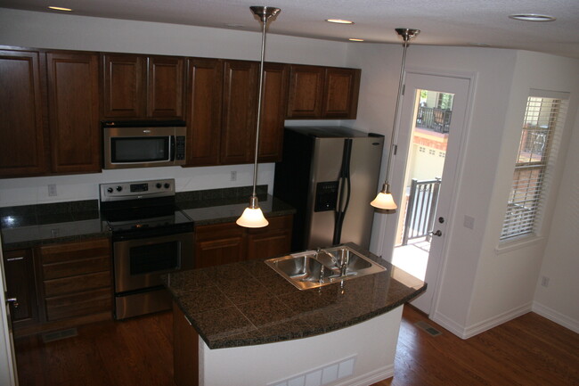 Kitchen with stainless steels appliances, granite counters, access to balcony - 9196 Kornbrust Dr