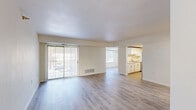 This 3-bedroom, 1-bathroom unit at 2329 Timberbrook Dr SE in Grand Rapids, Michigan offers a clean, functional layout spread across a single floor. Light-toned luxury vinyl plank flooring runs throughout, creating a cohesive and easy-to-maintain aesthetic. The open living and dining area is spacious and airy, bathed in natural light from large windows and a full-width sliding glass door fitted with vertical blinds that leads to an outdoor area. The kitchen is efficiently designed in a galley style, featuring crisp white cabinetry, marble-look countertops, a double stainless steel sink with a brushed gold faucet, and stainless steel appliances including a refrigerator, range, and dishwasher. A pass-through opening connects the kitchen to the living space, enhancing the open feel. Each of the three bedrooms offers comfortable proportions, with the primary bedroom providing generous space and a sliding-door closet for storage. Additional bedrooms are bright, with natural light filtering in through windows. The full bathroom is well-appointed with a white vanity featuring a marble-look countertop, a combination tub and shower, and coordinating brushed nickel fixtures, all finished with the same wood-look flooring found throughout the unit.