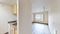 Located at 1240 SW Columbia St in Portland, Oregon, this one-bedroom, one-bathroom unit offers a thoughtfully organized single-floor layout. Light wood-style flooring flows consistently throughout the space, contributing to a clean, cohesive aesthetic.

The combined living and dining area serves as the heart of the unit, featuring a large wood-trimmed window that frames views of the surrounding Portland cityscape and greenery, filling the room with natural light. Track lighting on the ceiling provides adjustable illumination for the space. The kitchen is positioned adjacent to this open area, equipped with light wood cabinetry, a countertop sink, and functional storage.

The bedroom is a well-proportioned private retreat, also featuring a wood-trimmed window with city views and a wall sconce light fixture. A sliding wood-door closet provides dedicated storage, and two additional closets elsewhere in the unit offer further organizational flexibility.

The bathroom is clean and straightforward, featuring light wood-style flooring consistent with the rest of the unit, a vanity with warm wood cabinetry, a countertop sink, a bathtub, and chrome grab bars. Textured ceilings are present throughout the unit. An entrance foyer provides a defined transition point into the living space.
