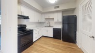 Located at 600 Whispering Hills Dr in Nashville, Tennessee, this two-floor residence offers a well-appointed layout with a blend of modern updates and comfortable living spaces throughout. The kitchen is a functional highlight, featuring crisp white shaker cabinetry, light marble-look countertops, a stainless steel sink, and a full suite of black appliances including a range, dishwasher, and refrigerator, all set atop warm wood-look laminate flooring. The main living area is generously sized, bathed in natural light from a large sliding glass door fitted with vertical blinds that opens directly to an outdoor patio area with views of a lush green yard. Additional rooms on the lower level include a bathroom with wood-look flooring and brushed nickel fixtures. The upper floor houses multiple bedrooms, each carpeted in neutral tones and featuring textured ceilings, closets, and windows with blinds that allow for ample natural light. Bathrooms on this level are clean and simply appointed with wood-look flooring and brushed nickel hardware. Throughout the space, a consistent neutral color palette and updated finishes create a cohesive, move-in-ready atmosphere suited for comfortable everyday living in the heart of Nashville.