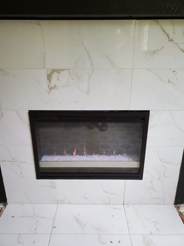 New electric fireplace with thermostat controlled heat-a-lator and remote to change lights to suit your mood. Marble surround. - 7091 Beech Street