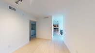 Located at 601 Northwest 82nd Avenue in Plantation, FL, this well-appointed two-bedroom, two-bathroom residence offers a thoughtfully designed single-floor layout with a comfortable sense of space throughout. The living area is a standout feature, boasting a dramatic curved bay window wall that floods the room with natural light and offers views of the surrounding community. A ceiling fan adds comfort, and access to a private balcony enhances the airy feel of this central gathering space. The kitchen is outfitted with warm wood cabinetry, dark granite countertops, stainless steel appliances including a French door refrigerator, and track lighting overhead — all set atop large-format light tile flooring that extends through the main living areas. A dedicated laundry room with a full-size washer and dryer adds everyday convenience. The primary bedroom is generously sized, featuring wood-look flooring and natural light, with an en-suite bathroom equipped with both a soaking tub and a separate glass-enclosed shower finished in neutral tile. The second bedroom also features wood-look flooring and a bright window. The second bathroom offers a tub-shower combo with large-format tile surround and dark granite vanity accents. A dedicated closet completes the layout.