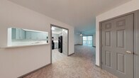 This single-floor residence at 800 Beresford Cir in Stone Mountain, Georgia, offers a thoughtfully updated interior with a clean, neutral palette throughout. The open layout connects a welcoming entryway to a generously sized living room, which features plush carpeting, a ceiling fan with light fixture, and a sliding glass door that opens to an outdoor patio, allowing natural light and outdoor views to flow into the space.

The kitchen is equipped with grey shaker-style cabinetry, white quartz countertops, a white subway tile backsplash, and black appliances including a range and refrigerator. Light wood-look flooring and a pass-through window to the adjacent area complete the functional yet stylish kitchen design.

The bedrooms are carpeted and well-lit by natural light through blinded windows. Each room offers ample wall space, and at least one bedroom includes a built-in closet with double doors and clothing rods. One bedroom features direct access to a bathroom, providing added convenience.

The bathrooms are finished with grey vanity cabinets, white countertops, framed mirrors, wood-look tile flooring, and tiled shower surrounds, maintaining a consistent modern aesthetic throughout the unit. The overall design emphasizes clean lines, updated finishes, and a bright, move-in-ready atmosphere.