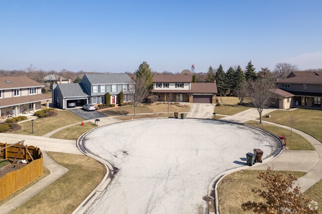 Homes in Oak Forest are lined with sidewalks and green lawns.