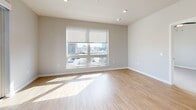 Located at 7831 E Union Ave in Denver, CO, this thoughtfully designed one-bedroom, one-bathroom unit offers a clean, contemporary aesthetic across a single floor. Light wood-tone flooring flows throughout the main living areas, complementing a bright, neutral color palette. The open-concept kitchen, dining, and living area serves as the heart of the unit, featuring a central island with pendant lighting, white shaker cabinetry, a classic subway tile backsplash, stainless steel appliances, and open wood shelving for added character. A wide window in the living area invites generous natural light and urban views of the Denver skyline. The bedroom is a comfortable, well-proportioned retreat with plush carpet, a ceiling fan, a window with city views, and access to a dedicated closet with built-in shelving. The bathroom includes a full soaking tub with a marble-style tiled surround and wood-tone flooring. In-unit laundry is conveniently accommodated with a stacked washer and dryer. A hallway and utility room complete the efficient, well-organized layout, making this a practical and stylish urban residence.