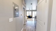 This E2 studio at 8225 Dorado Dr in Odessa, TX offers a thoughtfully designed open-concept layout that seamlessly combines the living, sleeping, and kitchen areas into one cohesive space. Wood-look plank flooring runs throughout, lending warmth and continuity, while neutral gray walls and recessed lighting create a clean, modern aesthetic.

The main living area is bright and welcoming, featuring large windows and French doors that invite natural light and provide access to the outdoors. A ceiling fan keeps the space comfortable year-round. The kitchen is integrated along one wall and includes dark espresso cabinetry with brushed nickel hardware, granite-style countertops, a stainless steel side-by-side refrigerator, and a sink — all designed to maximize efficiency without sacrificing style.

The sleeping area flows naturally from the living space, defined by framed wall art and a generous window that adds to the airy feel of the room.

The full bathroom is well-equipped with a dark wood vanity, granite countertop, an oversized mirror with overhead lighting, above-vanity storage cabinetry, and wood-look tile flooring — delivering a polished, functional finish. This compact yet complete studio is ideal for those seeking a low-maintenance, modern living space in Odessa.