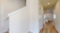 Located in Sugar Hill, GA, this two-story home offers five bedrooms and four bathrooms across two well-proportioned floors. The main level features a bright, modern kitchen equipped with white shaker-style cabinetry, granite countertops, stainless steel appliances including a gas range and built-in microwave, and a central island with a sink — all set atop light-toned luxury vinyl plank flooring. Recessed lighting enhances the clean, open feel of the space. The attached garage provides convenient enclosed parking with a paneled door and concrete flooring. Upstairs, the bedrooms offer a mix of LVP and plush carpeted flooring, with ceiling fans and natural light flowing through window-blind-covered windows. The generously sized primary bedroom includes its own well-appointed bathroom featuring granite vanity countertops, white cabinetry, a walk-in tiled shower, and a vertical privacy window. Additional bathrooms throughout the home include tub-shower combinations with tile surrounds, granite vanities, and LVP flooring. A hallway connects the upper-level rooms, finished with crisp white trim and two-panel doors. The home presents a clean, neutral palette throughout, offering a move-in ready aesthetic ideal for modern living.