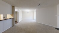 This single-story, 2-bedroom, 1-bathroom residence offers a functional and comfortable layout across a well-utilized floor plan. The open living room is a standout feature, highlighted by a classic white-mantled fireplace flanked by built-in shelving, plush carpeting, and a textured ceiling that adds depth to the space.

The galley-style kitchen is efficiently designed with warm honey-toned cabinetry, granite-look countertops, wood-look flooring, and stainless steel appliances including an electric range, built-in microwave, dishwasher, and refrigerator. A convenient closet pantry provides additional storage.

The primary bedroom is a comfortable, well-sized retreat featuring plush carpet, a ceiling fan with light fixture, and a window that invites natural light. It connects to a dedicated walk-in closet outfitted with wire shelving on two walls, offering ample storage. The second bedroom also features wood-look flooring and two windows for abundant natural light.

The full bathroom includes a soaking jetted tub and shower combination with clean white surround finishes. Throughout the residence, neutral cream and beige tones create a cohesive, inviting ambiance ready for personalization.
