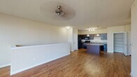 Located at 1809 Meeting St in Lexington, Kentucky, this single-floor residence offers a well-designed layout that balances functionality and comfort. The open-concept living and kitchen area is anchored by rich hardwood-style flooring and ceiling fan, creating a welcoming communal space. The kitchen is a standout feature, equipped with dark espresso cabinetry, granite-style countertops, a full suite of black appliances including a refrigerator, range, microwave, and dishwasher, and a large center island with pendant lighting overhead. A built-in wine rack accent and a dedicated pantry with wire shelving add both style and practicality. The bedrooms are carpeted for warmth and comfort, each featuring ceiling fans or overhead lighting, large windows that invite natural light and outdoor views, and generous closet space. Walk-in closets with wire shelving systems provide excellent storage capacity. The bathrooms are finished with hardwood-style flooring, dark vanities with granite-style countertops, and full tub-shower combinations with chrome fixtures. Neutral tones throughout the home create a clean, cohesive aesthetic that is easy to personalize.