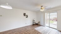 Located at 400 Hayden Rd in Tallahassee, FL, this single-story, one-bedroom, one-bathroom home offers a well-organized layout with a clean, bright aesthetic throughout. Rich wood-look flooring flows seamlessly across every room, creating a warm and cohesive feel.

The living room is an inviting, open space anchored by a ceiling fan with light kit and a sliding glass door that opens to a private outdoor patio, filling the room with natural light and providing convenient outdoor access. The front entry door leads directly into this comfortable living area.

The kitchen features light wood cabinetry, generous counter space, a double-basin stainless steel sink beneath a window, and a dishwasher — offering both functionality and a bright workspace. 

The bedroom is a well-sized, tranquil retreat with its own ceiling fan and a large window overlooking greenery outside, allowing for ample natural light. A dedicated walk-in closet with wire shelving provides practical storage.

The bathroom includes a full shower-tub combination, while a separate dedicated laundry area houses a full-size washer and dryer. A hallway connects the rooms efficiently, completing the smart and functional floor plan of this Tallahassee home.