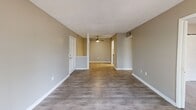 Located at 105 Cavalier Dr in Greenville, SC, this single-floor, 2-bedroom, 3-bathroom home offers a well-organized layout designed for comfortable everyday living. The open living area features hardwood-style flooring and a ceiling fan, flowing seamlessly into the kitchen through a convenient pass-through opening. A sliding glass door in the living room fills the space with natural light and provides direct access to a private balcony with outdoor views.

The kitchen is thoughtfully appointed with white cabinetry, granite countertops, a classic subway tile backsplash, stainless steel appliances — including a refrigerator, range, microwave, and dishwasher — and a skylight that adds additional brightness. In-unit washer and dryer connections are also present.

Both bedrooms are carpeted for warmth and comfort, each featuring windows that bring in natural light. The generously sized primary bedroom includes a closet and connects to its own bathroom. The bathrooms are finished with granite-topped vanities, white cabinetry, and tub-shower combinations, maintaining a consistent, clean aesthetic throughout.

Neutral warm-gray tones on the walls and white trim unify the interior, creating a cohesive and inviting atmosphere across every room.