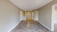 Located at 105 Cavalier Dr in Greenville, SC, this single-floor, 2-bedroom, 3-bathroom home offers a well-organized layout designed for comfortable everyday living. The open living area features hardwood-style flooring and a ceiling fan, flowing seamlessly into the kitchen through a convenient pass-through opening. A sliding glass door in the living room fills the space with natural light and provides direct access to a private balcony with outdoor views.

The kitchen is thoughtfully appointed with white cabinetry, granite countertops, a classic subway tile backsplash, stainless steel appliances — including a refrigerator, range, microwave, and dishwasher — and a skylight that adds additional brightness. In-unit washer and dryer connections are also present.

Both bedrooms are carpeted for warmth and comfort, each featuring windows that bring in natural light. The generously sized primary bedroom includes a closet and connects to its own bathroom. The bathrooms are finished with granite-topped vanities, white cabinetry, and tub-shower combinations, maintaining a consistent, clean aesthetic throughout.

Neutral warm-gray tones on the walls and white trim unify the interior, creating a cohesive and inviting atmosphere across every room.