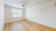 Located at 6204 Roscoe Ln in Knoxville, TN, this single-floor, 2-bedroom, 2-bathroom home offers a clean, modern aesthetic throughout. Light wood flooring flows seamlessly across all rooms, complementing the bright white walls and creating a warm, cohesive atmosphere.

The kitchen is a standout feature, boasting rich wood-toned cabinetry, granite countertops, and a full suite of stainless steel appliances including a refrigerator, range, and microwave. A spacious kitchen island with an undermount sink and granite surface serves as both a functional workspace and a natural connection to the living area, which is illuminated by recessed lighting.

Both bedrooms are generously sized, with the primary bedroom offering a comfortable footprint. Each bedroom features light wood floors, ceiling fans with lighting, and windows that frame pleasant outdoor views, allowing natural light to fill the space. A dedicated closet provides additional storage.

The two bathrooms maintain the home's clean design, with light wood flooring, white tile surrounds in the tub/shower, and brushed nickel fixtures. The overall layout is efficient and well-organized, with each room flowing naturally into the next, making the home feel open and inviting throughout.