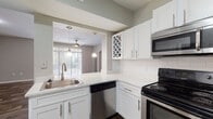 Located at 12401 W Hillsborough Ave in Tampa, Florida, this single-floor residence offers a thoughtfully designed layout with a warm, functional aesthetic throughout. The open living area serves as the heart of the home, featuring rich wood-look flooring, neutral taupe walls, and a ceiling fan that promotes comfortable airflow. Elegant arched doorways connect the living space to the rest of the home, adding a touch of architectural character. Large sliding glass doors with vertical blinds fill the living area with natural light and offer views of the outdoors.

The kitchen is well-equipped with crisp white cabinetry, light countertops, and a classic white subway tile backsplash. Stainless steel appliances—including a range, microwave, and dishwasher—complement the clean design. A pass-through window connects the kitchen to the dining and living areas, enhancing the open feel.

The bedrooms are carpeted for comfort and each features a ceiling fan, natural light from windows with blinds, and generous closet space with bifold doors. The bathrooms are clean and functional, each offering a tub/shower combination, wood-look flooring, and a vanity with light countertops. This residence presents a cohesive, move-in-ready living environment in a convenient Tampa location.