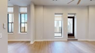 Located in Baltimore, MD, this well-appointed 2-bedroom, 4-bathroom residence offers a thoughtfully designed single-floor layout with generous living space. The open living area is bathed in natural light through large windows and features warm hardwood flooring, neutral tones, and direct access to an outdoor terrace through a full-glass door. Built-in shelving adds both function and character to the living space, which is also equipped with a ceiling fan and recessed lighting.

The gourmet kitchen is a standout feature, showcasing rich dark-wood cabinetry, granite countertops, a glass tile backsplash, and a full suite of stainless steel appliances including a gas range, microwave, and refrigerator. A kitchen island with an undermount sink, pendant lighting, and integrated dishwasher adds to its functionality.

Both bedrooms are generously sized and carpeted, offering a comfortable retreat. The primary bedroom is particularly spacious and benefits from tall, oversized windows that frame city views and flood the room with natural light. The four bathrooms are finished with tile flooring and granite-topped vanities, with at least one featuring a full soaking tub and shower combination with brushed nickel fixtures. The layout is completed by multiple hallways, a closet, and well-distributed utility spaces throughout.