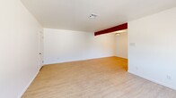 Located at 604 E Orange Grove Ave in Burbank, CA, this single-story, one-bedroom, two-bathroom home offers a bright and cleanly designed living space. Throughout the home, light wood laminate flooring contributes to a cohesive and airy aesthetic, complemented by white walls and clean lines.

The spacious living room is one of the home's standout features, bathed in natural light through a large front-facing window dressed with sheer curtains. A decorative exposed beam adds a subtle architectural accent, while multiple doorways provide easy flow throughout the layout.

The generously sized primary bedroom offers comfortable proportions, a window with soft natural light, and direct access to additional rooms within the home.

The kitchen is well-appointed with white shaker cabinetry, striking marble-veined quartz countertops, a stainless steel undermount sink, and a window above that brings in natural light and outdoor views. The clean tile backsplash completes the polished look.

Both bathrooms are finished with a consistent, modern palette — white vanities with quartz countertops, illuminated mirrors, mosaic tile flooring, and brushed nickel hardware — giving each a fresh and functional feel. The home's overall design prioritizes brightness, simplicity, and efficient use of space.