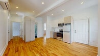 Located at 169 Union Street in Poughkeepsie, NY, this thoughtfully designed two-bedroom, one-bathroom unit offers a clean, modern aesthetic throughout its single floor. Warm honey-toned hardwood floors extend seamlessly across every room, creating a cohesive and inviting atmosphere.

The open-concept kitchen and living area serves as the heart of the unit, featuring crisp white and light wood cabinetry, a full suite of stainless steel appliances including a range, microwave, dishwasher, and refrigerator, and a subway tile backsplash. Recessed lighting brightens the space, which flows naturally into the living area.

The primary bedroom is a comfortable, well-proportioned retreat with arched double windows framing lush green outdoor views, a wall-mounted mini-split system for climate control, and a built-in wardrobe unit. The second bedroom is bright and airy, with large windows allowing generous natural light. Both rooms maintain the consistent hardwood flooring and clean white walls found throughout.

The bathroom is a standout feature, finished with large-format marble-look wall tiles in the glass-enclosed walk-in shower, dark herringbone floor tiles, a wall-mounted LED mirror, and a white vanity. The unit also includes a dedicated laundry area, two closets, and a hallway connecting the living spaces efficiently.