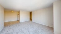 Located at 102 Avenue NW in Edmonton's vibrant Oliver neighbourhood, this well-laid-out 3-bedroom, 2-bathroom unit offers a comfortable and functional living environment across a single floor. The open living room is a standout feature, bathed in natural light through large sliding glass doors that lead to a private balcony overlooking the surrounding cityscape — a great vantage point of the Edmonton skyline and neighbourhood below. Soft carpet flooring runs throughout the living, dining, and bedroom areas, contributing to a warm and inviting atmosphere, while tile flooring is featured in the kitchen and bathrooms. The kitchen is equipped with white cabinetry, granite-style countertops, and a stainless steel sink, offering a practical and clean workspace. A separate dining area provides a defined space for meals. The primary bedroom is generously sized, featuring a large built-in closet and a bright window with outdoor views. The two additional bedrooms are well-proportioned, each with windows and baseboard heating. Both bathrooms are finished with tile flooring and light countertops — one includes a full tub-shower combination. With six closets distributed throughout, storage is plentiful. Textured ceilings and neutral tones give the entire unit a clean, consistent aesthetic.