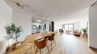 This 2-bedroom, 1-bathroom residence is thoughtfully laid out across a single floor, offering a functional and comfortable living environment. The open-concept design connects the kitchen, dining area, and living room into one cohesive space, promoting ease of movement and a sense of openness throughout.

The kitchen is outfitted with white shaker-style cabinetry, granite-look countertops, and a full suite of stainless steel appliances, including a range, microwave, dishwasher, and refrigerator. Light wood-tone flooring runs through the main living areas, complementing the bright, neutral color palette. The dining area features a track lighting fixture overhead and sliding panel doors that add a warm, wood-toned contrast to the light walls.

The living room is anchored by a large sliding glass door that invites abundant natural light and provides access to an outdoor space with views beyond. Both bedrooms are carpeted and feature generous sliding closets with built-in shelving. The primary bedroom offers a notably spacious footprint with ample closet storage.

The bathroom includes a full tub-shower combination with a clean, white surround and wood-tone flooring, maintaining the consistent design aesthetic found throughout the residence.