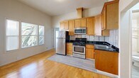 Located on Haste Street in Berkeley, CA, this efficient 2-bedroom, 1-bathroom unit offers a thoughtfully designed single-floor layout. Warm hardwood flooring flows throughout the main living areas, creating a cohesive and inviting atmosphere.

The open kitchen is a standout feature, equipped with stainless steel appliances including a gas range, microwave, and refrigerator. Rich wood cabinetry with dark granite countertops and a tile backsplash add a polished, functional touch. The kitchen connects seamlessly to the living area, making the space feel open and practical.

Both bedrooms are bright and functional, each featuring mirrored sliding closets that enhance the sense of space and provide ample storage. Windows in each room allow natural light to filter in, with views of surrounding greenery adding a pleasant outdoor connection.

The bathroom is well-appointed with a combination tub and shower enclosed in a glass sliding door, a wood vanity with dark granite countertop, and light tile flooring that ties the room together cleanly.

With its efficient layout, quality finishes, and prime Berkeley location near the University of California campus, this unit offers a practical and comfortable living environment well-suited for students or professionals seeking a well-maintained residence.