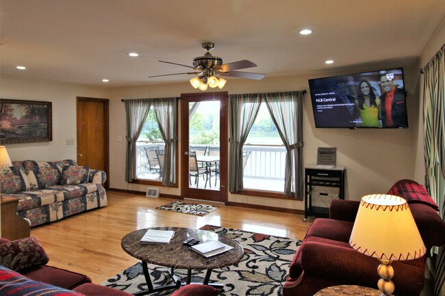 Large windows with deck overlooking the lake - 102 Holiday Ln