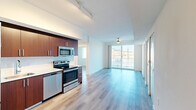 Located at 3235 Heritage Trail Blvd in Denton, TX, this modern single-floor unit offers three bedrooms and three bathrooms within a thoughtfully designed layout. The open-concept living and kitchen area is anchored by floor-to-ceiling sliding glass doors that flood the space with natural light and provide views of the surrounding area, complemented by a ceiling fan overhead. The kitchen is well-appointed with rich walnut-toned cabinetry, a white tile backsplash, light quartz-style countertops, and a full suite of stainless steel appliances including a refrigerator, range, microwave, and dishwasher. Track lighting above adds a contemporary touch. Light wood-look plank flooring runs consistently throughout the entire unit, creating a clean and cohesive aesthetic. Each bedroom features white walls, a ceiling fan or light fixture, a sliding-door closet, and windows that bring in natural light. The primary bedroom is accompanied by a dedicated closet space. The bathrooms are finished with warm wood-tone vanities, white countertops, and full tub-shower combinations featuring large-format beige tile surrounds. The hallway connects all rooms efficiently, and the overall design maintains a bright, neutral palette throughout.