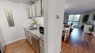 Located at 9800 Horton Rd SW in Calgary, AB, this well-appointed 1-bedroom unit offers a functional and comfortable layout across a single floor. The galley-style kitchen is a standout feature, equipped with stainless steel appliances including a range, dishwasher, and refrigerator, complemented by gray cabinetry and granite-look countertops. A tiled backsplash and stainless steel sink complete the practical yet stylish kitchen setup. The kitchen opens directly into the combined dining and living area, creating a cohesive, open feel. The living room is bathed in natural light thanks to large sliding glass doors that lead to a private balcony, offering pleasant outdoor views of surrounding greenery. Warm hardwood-style flooring runs throughout the main living spaces, adding continuity and warmth to the interior. The bedroom is a comfortably sized retreat featuring the same hardwood-style flooring, neutral walls, a textured ceiling, and mirrored sliding closet doors that enhance the sense of space. A hallway connects the main living areas and provides access to the in-unit laundry. Throughout the unit, a neutral color palette and clean finishes contribute to a bright, welcoming ambiance that is both practical and inviting.