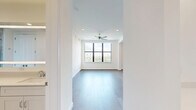 Located in Houston's desirable 77098 zip code, this thoughtfully designed one-bedroom, two-bathroom residence offers a refined living experience through high-end finishes and an efficient, well-organized layout. Rich hardwood floors flow throughout the open-plan living and kitchen areas, complemented by crisp white walls, crown molding, and recessed lighting that keep the interiors bright and airy.

The gourmet kitchen is a standout feature, showcasing custom shaker-style cabinetry, a marble-look quartz waterfall island, a marble tile backsplash, and a full suite of stainless steel appliances including a professional-grade gas range. Statement cage pendant lights add an elegant finishing touch.

The spacious living room benefits from large black-framed windows that frame impressive city skyline views, with a ceiling fan adding comfort. The generously sized primary bedroom mirrors this bright, open character with its own city-facing window and direct access to an en-suite bathroom. Both bathrooms are finished with full marble-look tile from floor to ceiling — one featuring a glass-enclosed walk-in shower and a backlit vanity mirror, the other a soaking tub. A dedicated closet and two hallways complete this polished, move-in-ready residence.