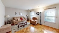 Located on Farmhouse Lane in Morris Plains, NJ, this two-bedroom, one-bathroom single-floor home offers a well-organized layout with a comfortable and functional living environment. The living room is a welcoming space featuring distinctive parquet wood flooring and multiple windows that allow natural light to fill the room, creating a bright and airy atmosphere. The open sightlines connect the living area to the dining room, enhancing the sense of space throughout the home.

The kitchen is equipped with warm honey-toned wood cabinetry, dark countertops, tile flooring, and white appliances including a range, dishwasher, refrigerator, and microwave. A window above the sink provides natural light and ventilation.

The primary bedroom is generously proportioned, offering parquet flooring, a ceiling fan with light fixture, a sliding glass door leading to the patio, and a built-in closet. The second bedroom also features parquet flooring, a ceiling fan, and a large sliding-door closet. The home includes four closets in total, providing ample storage throughout.

The bathroom is finished with large-format stone-look wall tiles surrounding the tub-shower combination, complemented by tile flooring. The private patio extends the living space outdoors, rounding out this well-appointed Morris Plains residence.
