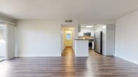 Located at 333 Andover Dr in Burbank, CA, this 2-bedroom, 2-bathroom residence offers a well-designed single-floor layout that maximizes functionality. The open-concept living and kitchen area serves as the heart of the home, featuring durable hardwood-style flooring that flows throughout the main living spaces. The living room is highlighted by a classic fireplace and a sliding glass door that opens onto a private balcony, filling the space with natural light and offering views of the surrounding neighborhood. The kitchen is equipped with stainless steel appliances — including a gas range, microwave, and refrigerator — complemented by white cabinetry, dark countertops, and a skylight that brightens the space. A peninsula counter provides a natural divide between the kitchen and living areas. A central hallway connects the bedrooms and bathrooms, with three closets offering ample storage throughout. The bedrooms feature plush carpeting and multiple windows that invite natural light. The primary bedroom is generously sized with its own dedicated closet. Both bathrooms are finished with clean, functional cabinetry. The unit also includes a private balcony with a metal railing, overlooking the community exterior under the Southern California sky.