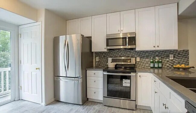kitchen with updated appliances - 4945 Noble Park Pl