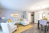 Located at 461 Forest Hill Rd in Macon, Georgia, this two-floor residence offers a well-appointed layout designed for comfortable everyday living. The kitchen is a standout feature, showcasing crisp white cabinetry, granite-look countertops, a dark subway tile backsplash, and black appliances including a range, microwave, dishwasher, and refrigerator. Natural light filters in through a window above the sink, complemented by wood-look flooring throughout. The kitchen flows seamlessly into a dedicated dining area, which is anchored by a modern chandelier, warm-toned wall art, and a light wood dining table surrounded by upholstered chairs. The living room provides a welcoming atmosphere with a spacious sectional sofa, accent seating, parquet-style flooring, and vertical blinds that allow for adjustable natural light. The bedroom features carpet flooring, multiple windows with views of surrounding greenery, and tasteful decorative accents. The bathroom includes a full tub-shower combination with coordinating fixtures. Throughout the home, neutral gray walls and carefully chosen décor create a cohesive, contemporary aesthetic that is both functional and inviting.