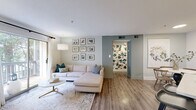 Located in Atlanta's vibrant Virginia-Highland neighborhood, this two-bedroom, one-bathroom residence offers a well-designed single-floor layout with a clean, modern aesthetic throughout. Wood-look flooring flows continuously across the living spaces, anchoring the bright, neutral palette that defines the interior.

The living room is a welcoming, light-filled space anchored by a large sliding glass door that opens to a private balcony with leafy outdoor views, allowing natural light to pour in. Adjacent to the living area, the dining space provides an intimate setting, while the kitchen impresses with two-tone cabinetry — crisp white uppers paired with slate-gray lowers — white quartz countertops, stainless steel appliances, a skylight, and a peninsula with bar seating that creates a seamless connection between kitchen and dining.

The primary bedroom is a comfortably sized retreat featuring a ceiling fan and hardwood-style flooring, while the second bedroom also offers a ceiling fan, a natural light window, and a relaxed, cozy feel. The full bathroom includes a tiled shower-tub combination. A dedicated in-unit laundry room with full-size washer and dryer adds everyday convenience, complemented by hallway access and a separate closet for storage.