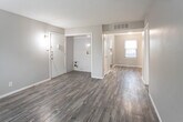 Located at 4640 52nd St in Lubbock, TX, this single-story home offers a practical and well-maintained layout across several distinct living areas. The main living spaces feature dark wood-style laminate flooring paired with neutral gray walls and textured ceilings, creating a clean, cohesive aesthetic throughout. Windows fitted with horizontal blinds allow natural light to filter in while maintaining privacy.

The kitchen is equipped with white cabinetry, a subway tile backsplash, and a full suite of black appliances, including a refrigerator, electric range, dishwasher, and over-the-range microwave. Light-toned wood-style flooring and a double basin sink complete the functional space.

The bedrooms feature plush carpeting and ceiling fans with integrated lighting. Each room includes a window with outdoor views, contributing to a comfortable and airy feel. A utility/laundry area with hookups is accessible from the interior.

The bathrooms include one with a tub-shower combination, white vanity, and wood-style flooring, and a second with a speckled quartz-style countertop vanity. The overall layout, visible in the 3D floor plan, flows logically and offers efficient use of the available space throughout the home.