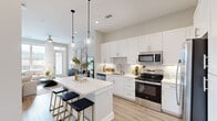 Located at 901 St Albans Dr in Raleigh, NC, this thoughtfully designed one-bedroom, one-bathroom residence offers a comfortable and modern single-floor layout. Light hardwood-style flooring flows throughout the main living areas, anchoring a bright and cohesive aesthetic.

The kitchen is a standout feature, showcasing crisp white shaker cabinetry extending to the ceiling, a classic subway tile backsplash, quartz countertops, and a full suite of stainless steel appliances including a French door refrigerator, electric range, built-in microwave, and dishwasher. A central island with pendant lighting above provides additional prep space and casual seating.

The open-concept layout connects the kitchen seamlessly to the living room, which is bathed in natural light from large windows and a glass-paneled door leading to an outdoor balcony. A ceiling fan adds comfort to the space.

The bedroom is generously sized, featuring plush carpet, a ceiling fan, and a large window that fills the room with natural light. An adjacent walk-in closet offers well-organized shelving and hanging storage. The bathroom features a dual-sink vanity with white cabinetry, quartz countertops, and a full tub with marble-style tile surround. A hallway connects the private areas of the residence efficiently.