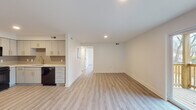 Located at 325 W Parkwood Dr in Dayton, Ohio, this single-floor home has been thoughtfully renovated with contemporary finishes and a clean, modern aesthetic. Light wood-tone luxury vinyl plank flooring runs throughout the living spaces, creating a bright and cohesive atmosphere complemented by crisp white walls and recessed lighting.

The open-concept living and dining area flows seamlessly, offering generous space for both relaxing and entertaining. A sliding glass door and multiple windows invite abundant natural light into the living area, providing views of the surrounding exterior.

The kitchen is a standout feature, equipped with sleek gray cabinetry accented by gold hardware, quartz countertops, a gray subway tile backsplash, and a full suite of black GE appliances including a refrigerator, range, over-the-range microwave, and dishwasher. A gold-tone faucet adds an elegant finishing touch.

The bedrooms are well-proportioned and bathed in natural light from surrounding windows, each outfitted with a ceiling fan and light fixture with warm gold tones that complement the overall design palette.

The bathroom features a clean white tub-shower combo, marble-look tile flooring, and sleek matte black fixtures and hardware, delivering a modern and polished look throughout.