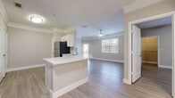 This well-appointed 4-bedroom, 2-bathroom single-story home offers a thoughtfully designed layout with modern finishes throughout. Light wood-look flooring flows seamlessly across the entire living space, complemented by warm neutral-toned walls and crisp white trim and crown molding that add an elegant touch to every room.

The open-concept living and dining area greets you upon entry, featuring a charming bay window that floods the space with natural light. The kitchen is a standout, boasting white shaker cabinetry, stone countertops, a peninsula with bar seating, a stainless steel refrigerator, and generous counter space — ideal for everyday cooking and entertaining.

The spacious primary bedroom is notably generous in size, featuring crown molding, a ceiling fan, and windows overlooking the outdoors. The three additional bedrooms are well-proportioned, each with large windows and ample natural light.

Both bathrooms are finished with white vanity cabinetry, stone countertops, brushed metal hardware, tile-surround soaking tubs, and wood-look tile flooring. A dedicated laundry room houses a full-size washer and dryer with overhead shelving for added storage. The home also includes a large attached garage, completing this comfortable and functional residence.